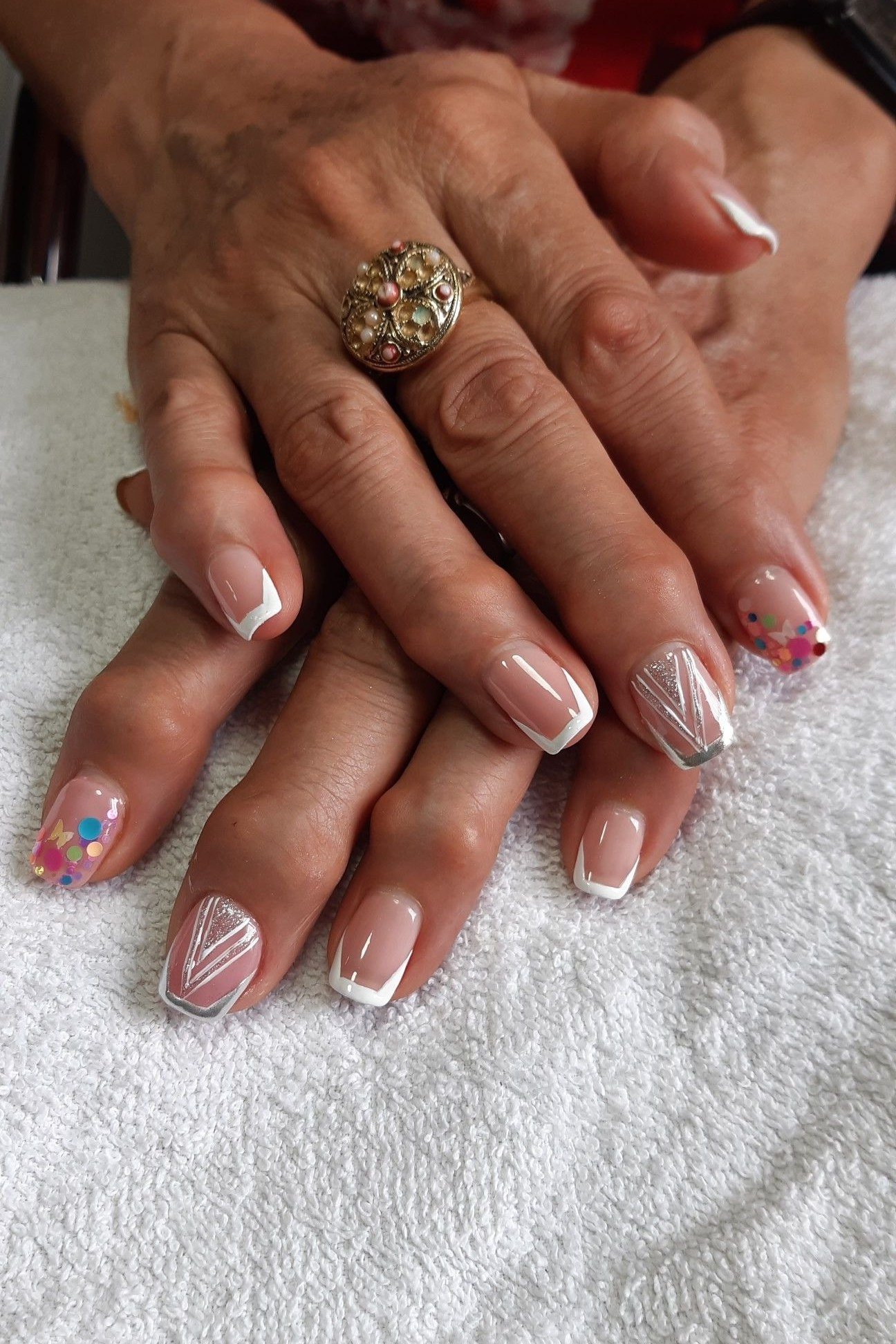 French Tips with Confetti Accents, french tip nails for women over 70, elegant manicure on mature hands