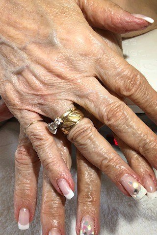 French Tips with Artistic Accent Nails, french tip nails for women over 70, elegant manicure on mature hands