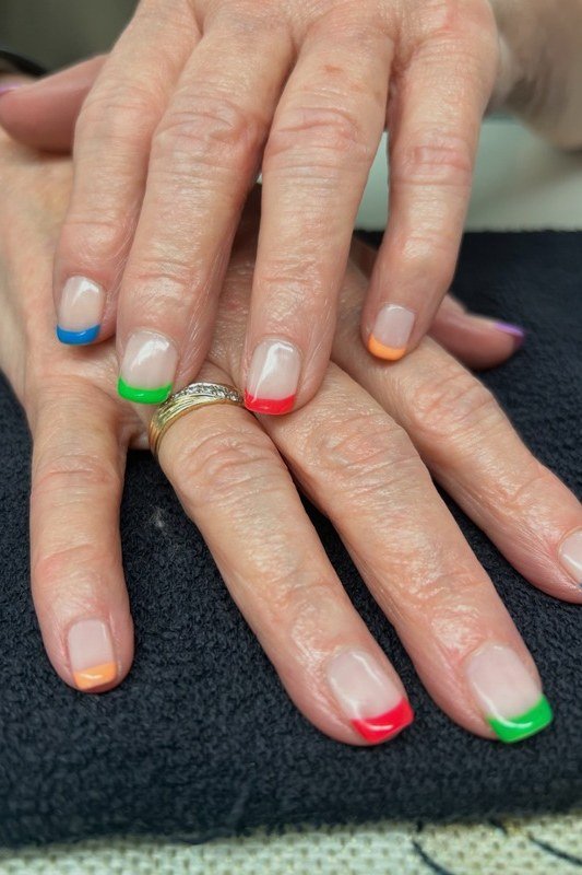 Rainbow French Tips, french tip nails for women over 70, elegant manicure on mature hands
