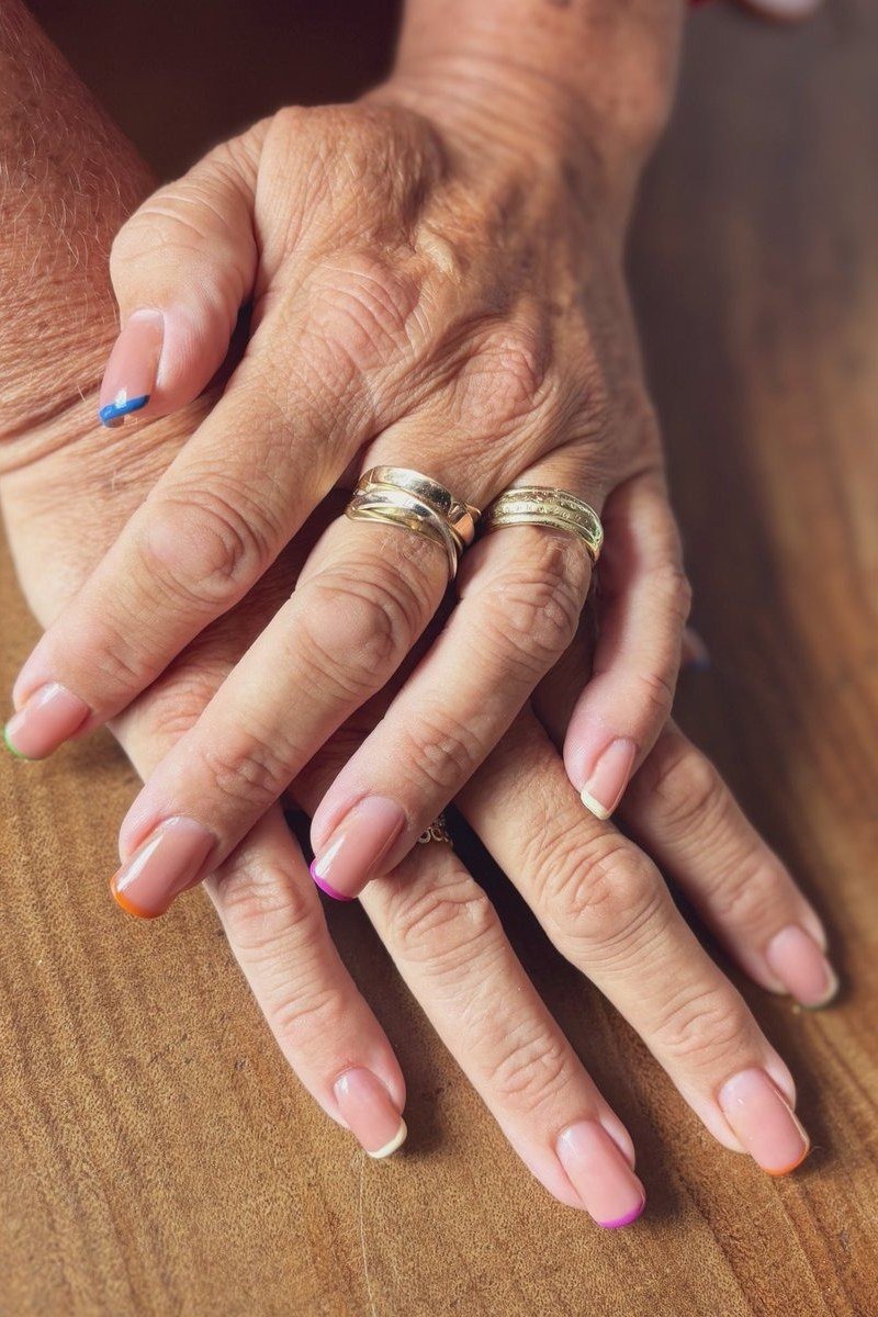 French Tips with Blue Accents, french tip nails for women over 70, elegant manicure on mature hands