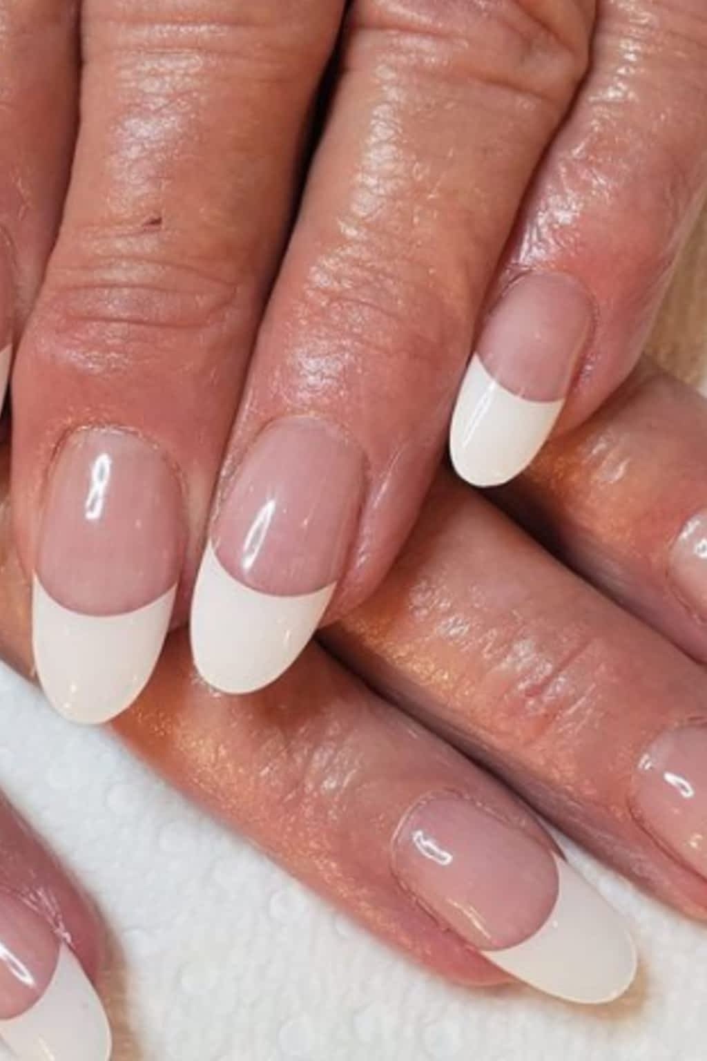 Pink and white french manicure on mature hands