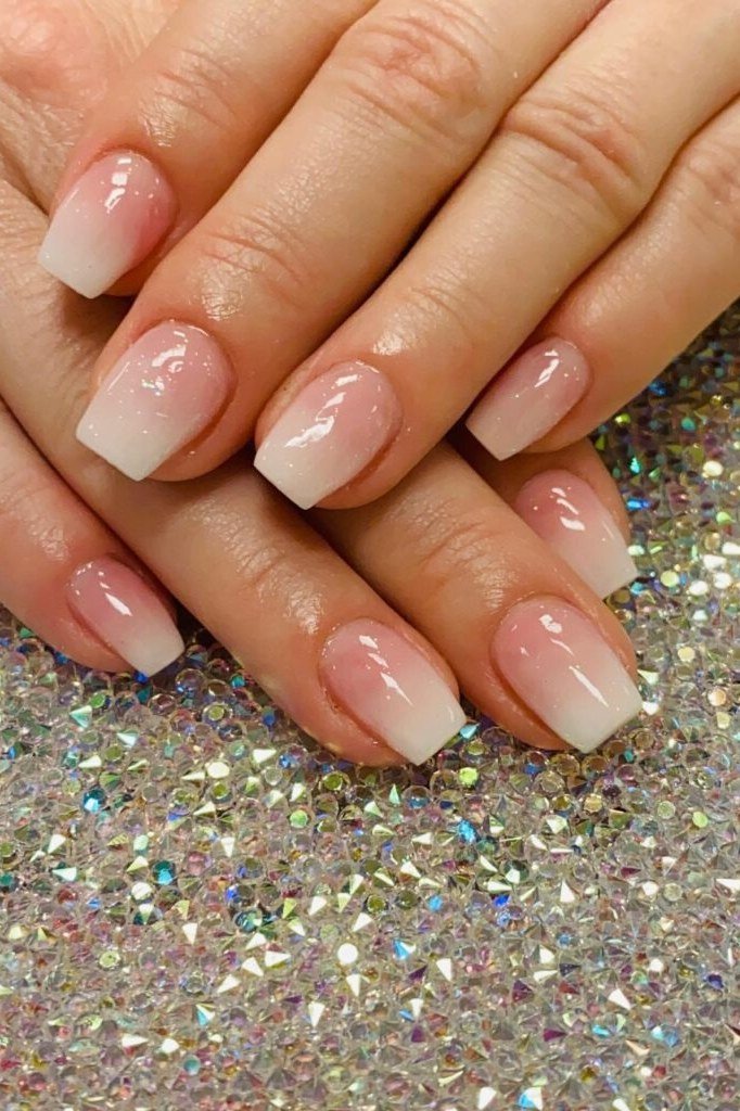 Baby-boomer ombre french nails on a glittery background