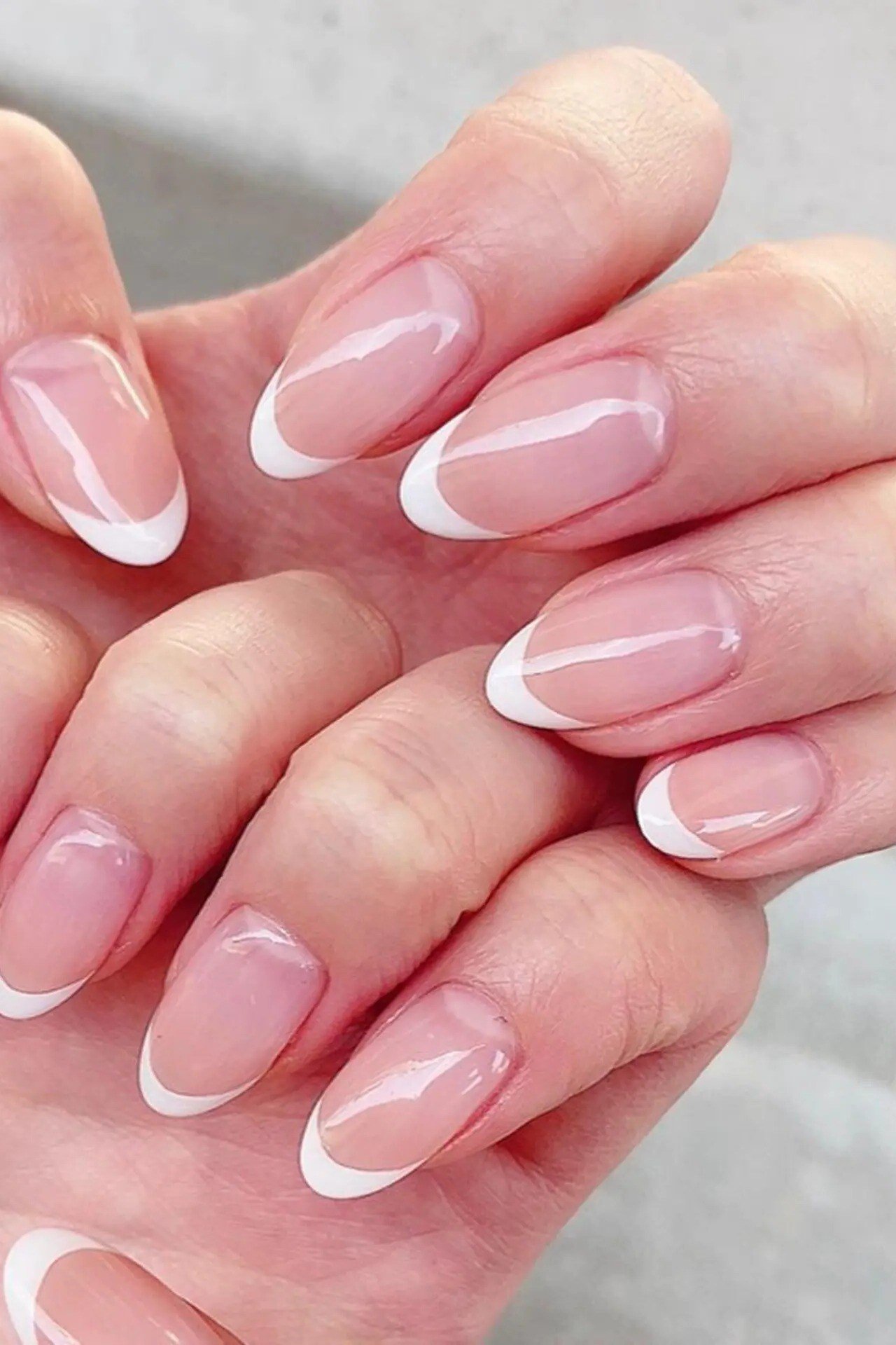 Almond glossy french manicure closeup