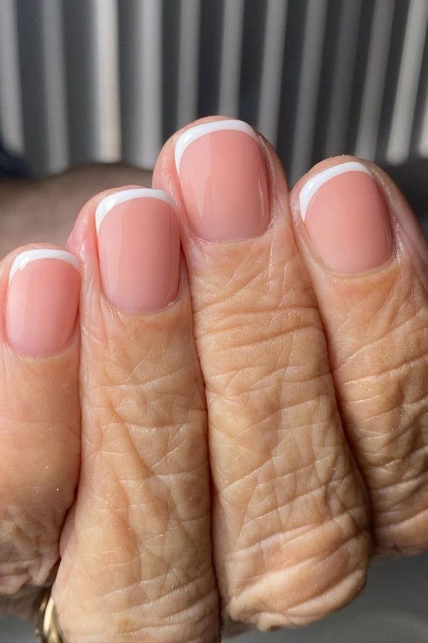Macro closeup of french tips on elderly fingers