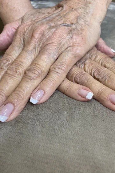 French manicure on elderly hands