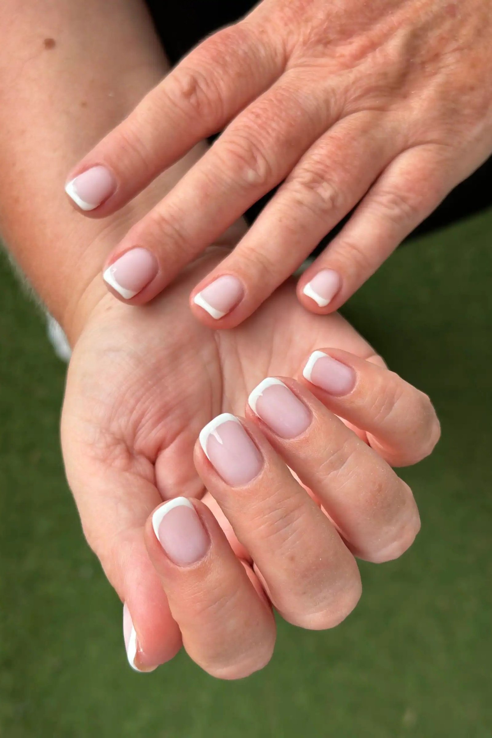 Hand and palm pose showing a french manicure