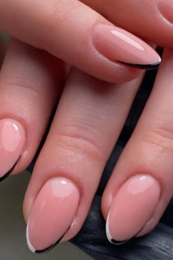 Black-tipped french manicure on a pink base