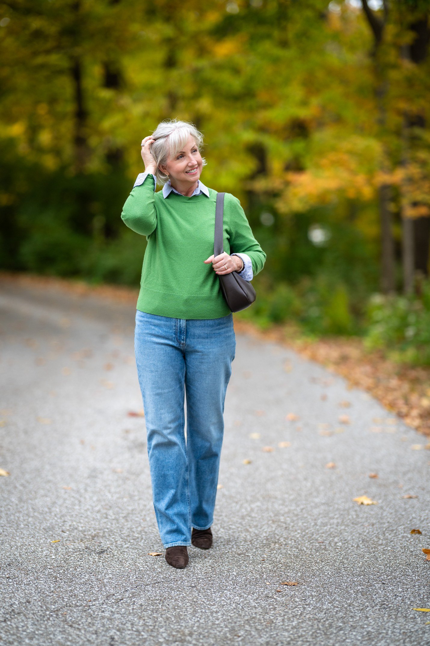 Fall sweater outfit idea 18 for women over 60: green sweater with blue jeans