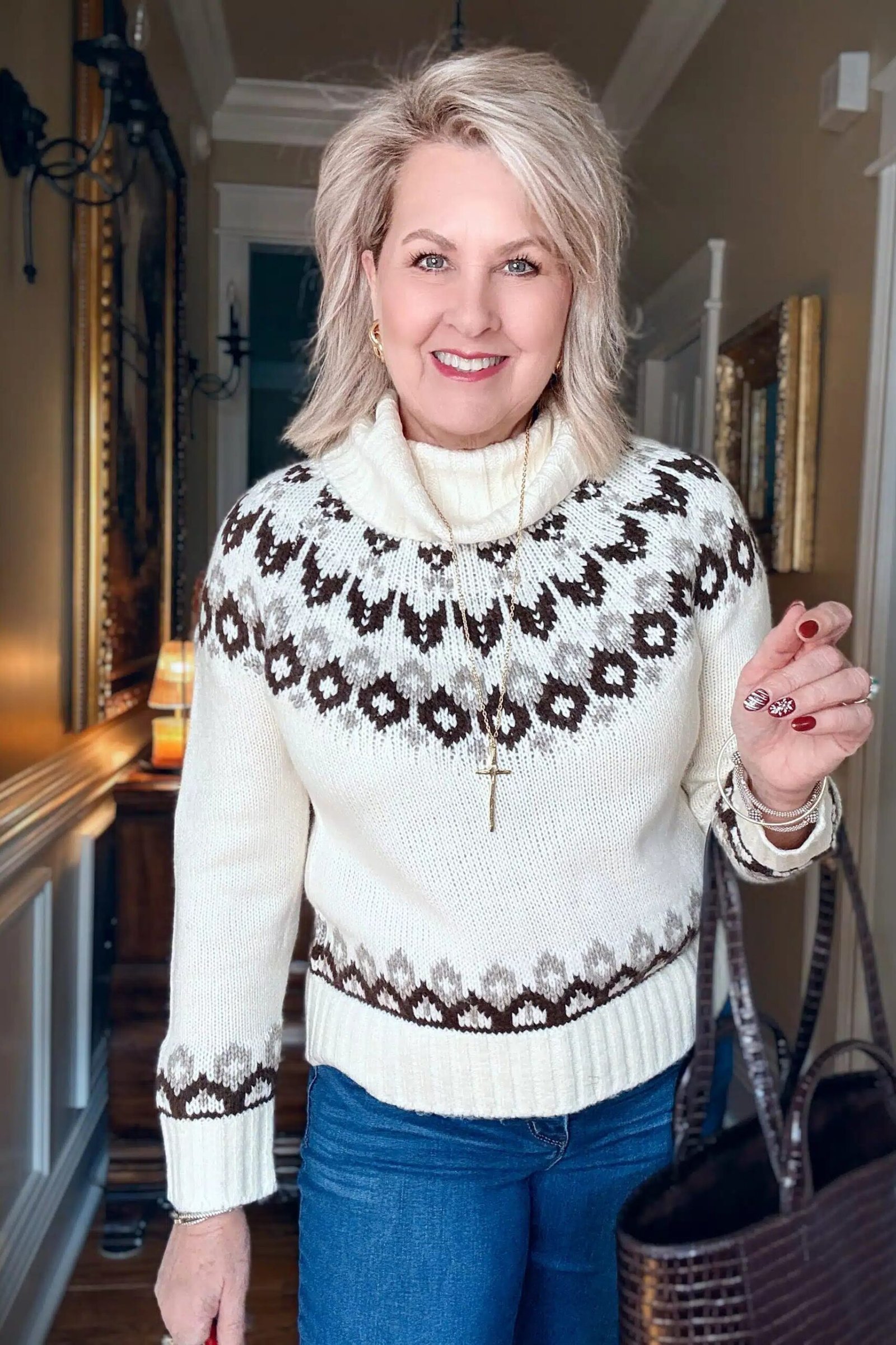 Fall sweater outfit idea 52 for women over 60: cream fair isle turtleneck with blue jeans