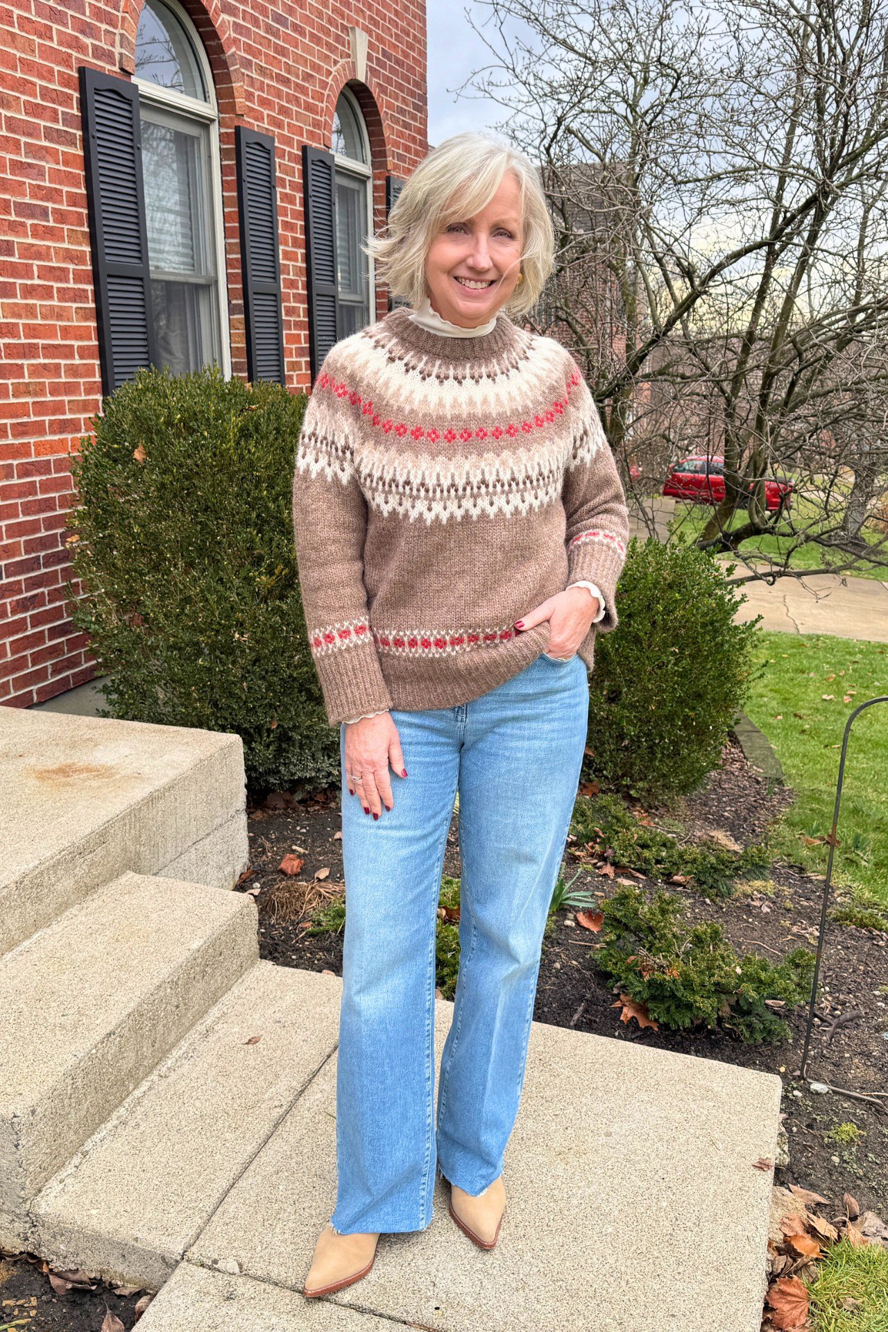 Fall sweater outfit idea 53 for women over 60: taupe fair isle with blue jeans