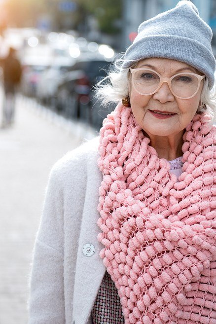 Fall sweater outfit idea 65 for women over 60: pink chunky scarf with beanie and light coat