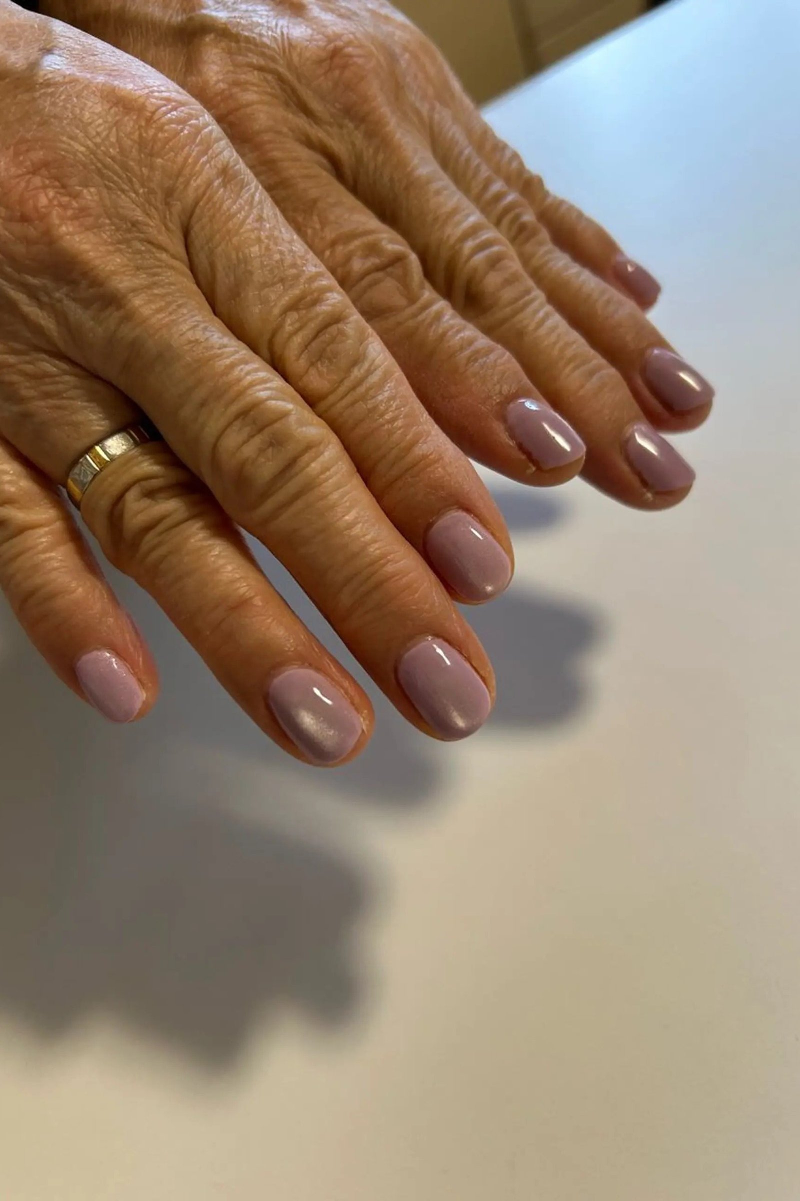 Mauve Nails with Gold Ring - gel nail design for women over 50