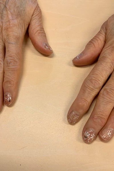 Sheer Glitter Nails on Aged Hands - gel nail design for women over 50