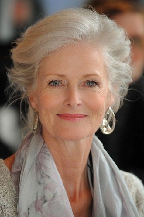 Soft swept-up silver updo hairstyle, elegant front view of older woman