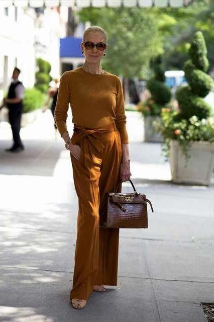 Woman over 70 in rust sweater and rust wide-leg pants