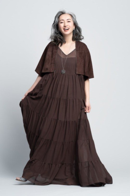Older woman in brown tiered maxi dress