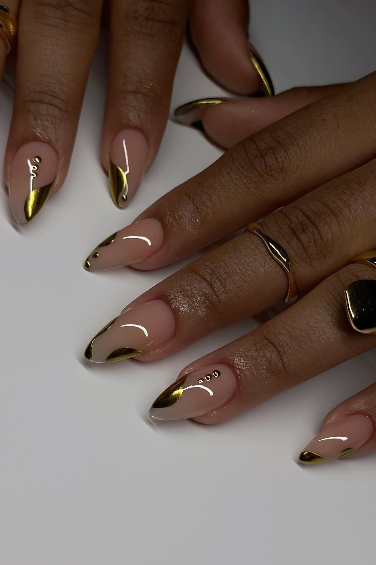 Gold chrome French tips with tiny gold dots on nude nails, flattering gold nails for dark skin