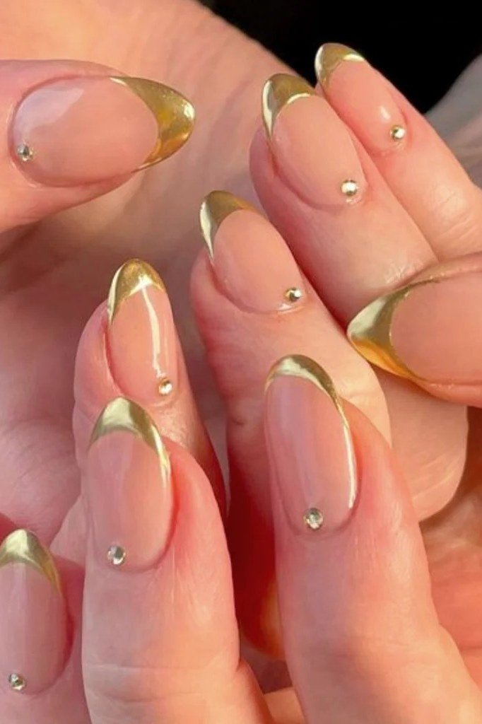 Nude nails with gold French tips and tiny rhinestones near cuticles, delicate gold wedding nails