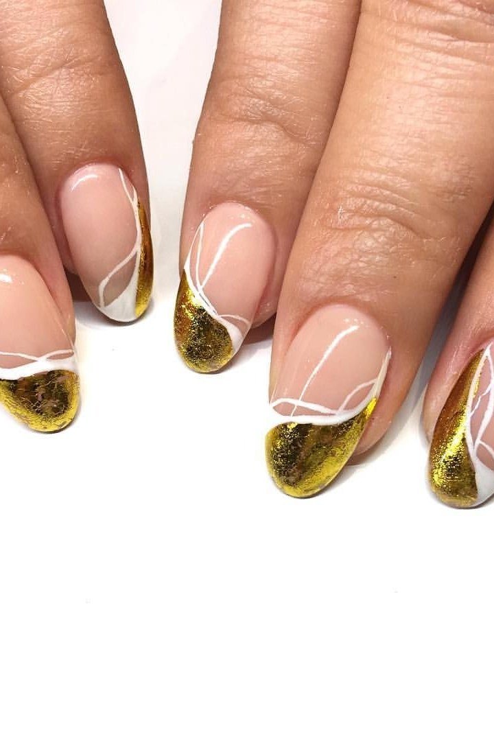 Gold foil French tips with white swirl line art on nude nails, artistic gold wedding nails