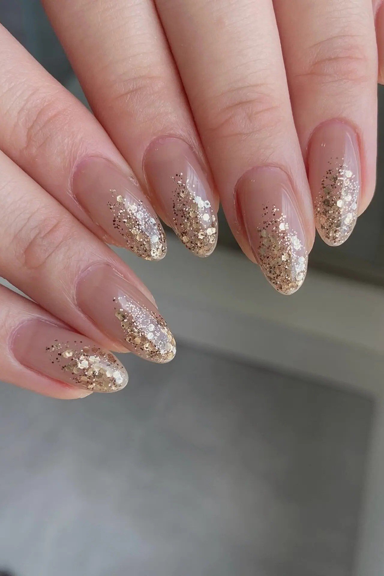 Gold glitter ombre fade on nude almond nails, sparkly gold wedding nails