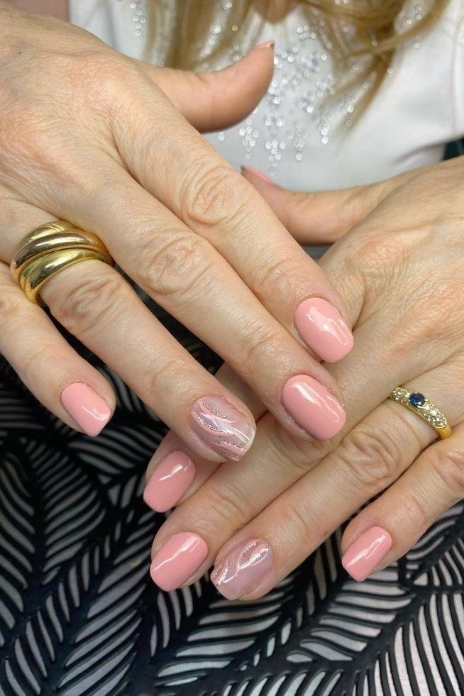 pink nails with glitter accent nail on older hands, sparkling elegant manicure