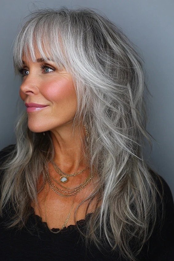 Long Silver Waves with Curtain Bangs for women over 60, grey hairstyle with bangs