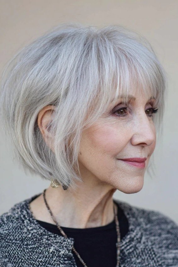Chin-Length Silver Bob with Soft Eyebrow Bangs for women over 60, grey hairstyle with bangs