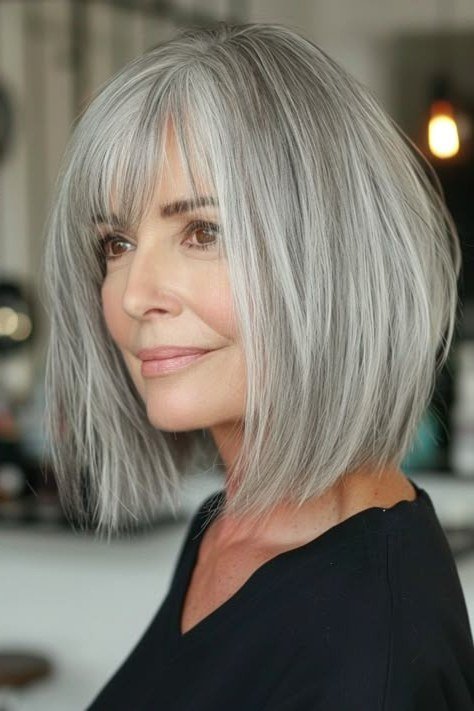 Tousled Silver Lob with Wispy Bangs for women over 60, grey hairstyle with bangs