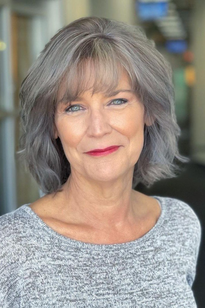 Salt-and-Pepper Shaggy Bob with Wispy Bangs for women over 60, grey hairstyle with bangs
