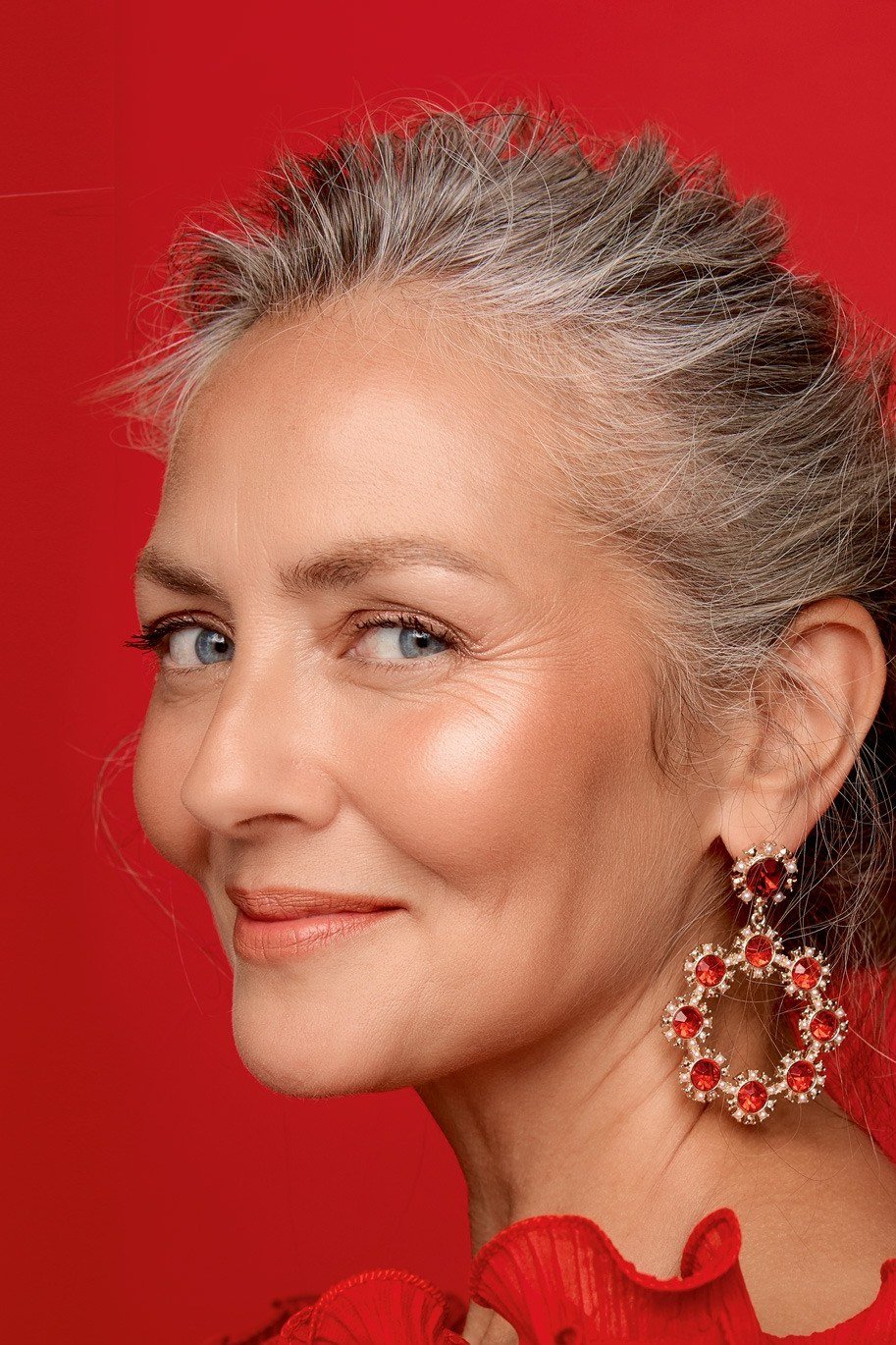 Silver-Gray Festive Updo With Red Earrings - Christmas party hairstyle for women over 60 (silver-gray festive updo with red earrings, three-quarter view)