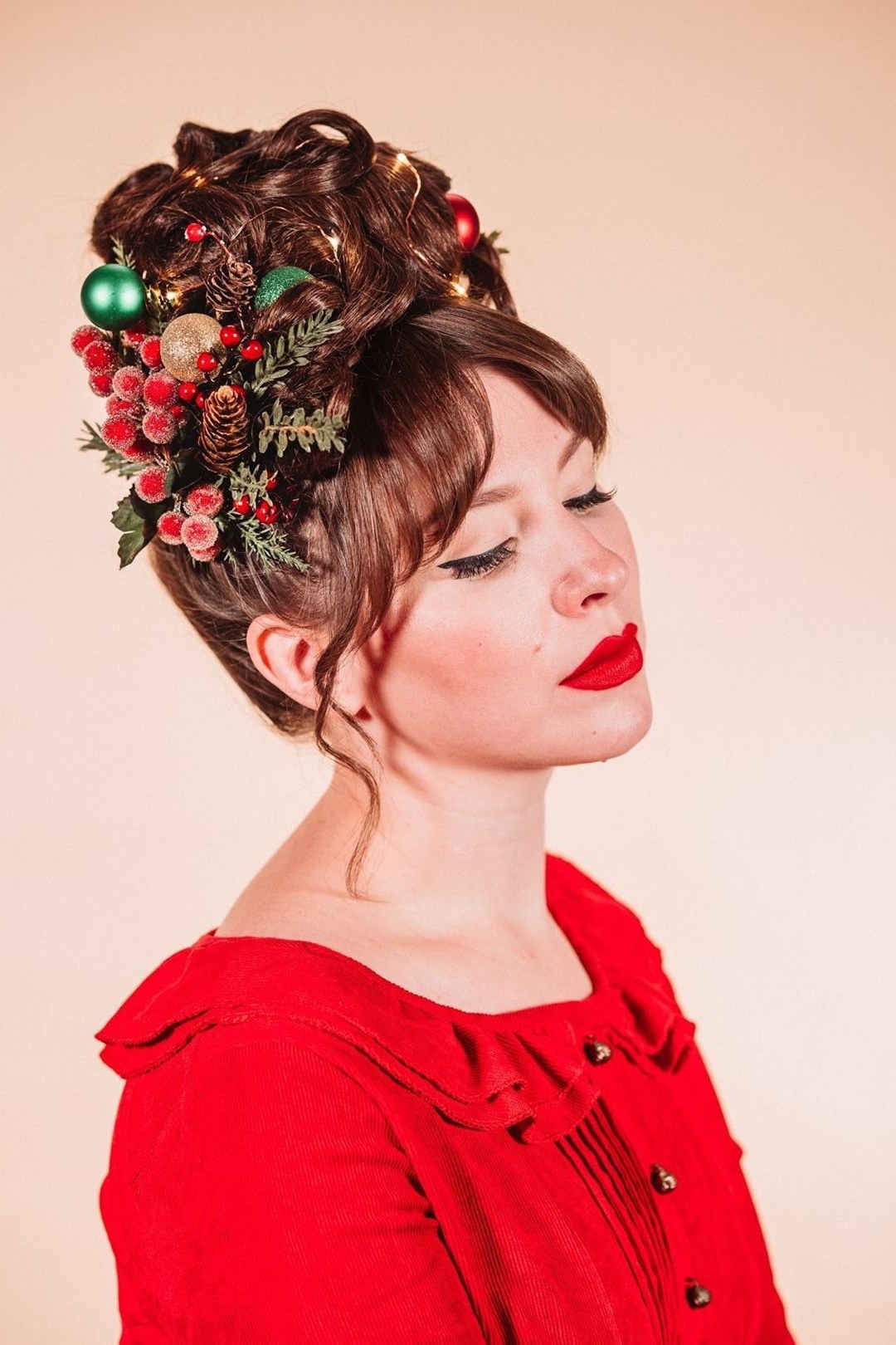 Brown Updo With Christmas Berry Pins - Christmas party hairstyle for women over 60 (brown updo with christmas berry pins, three-quarter view)