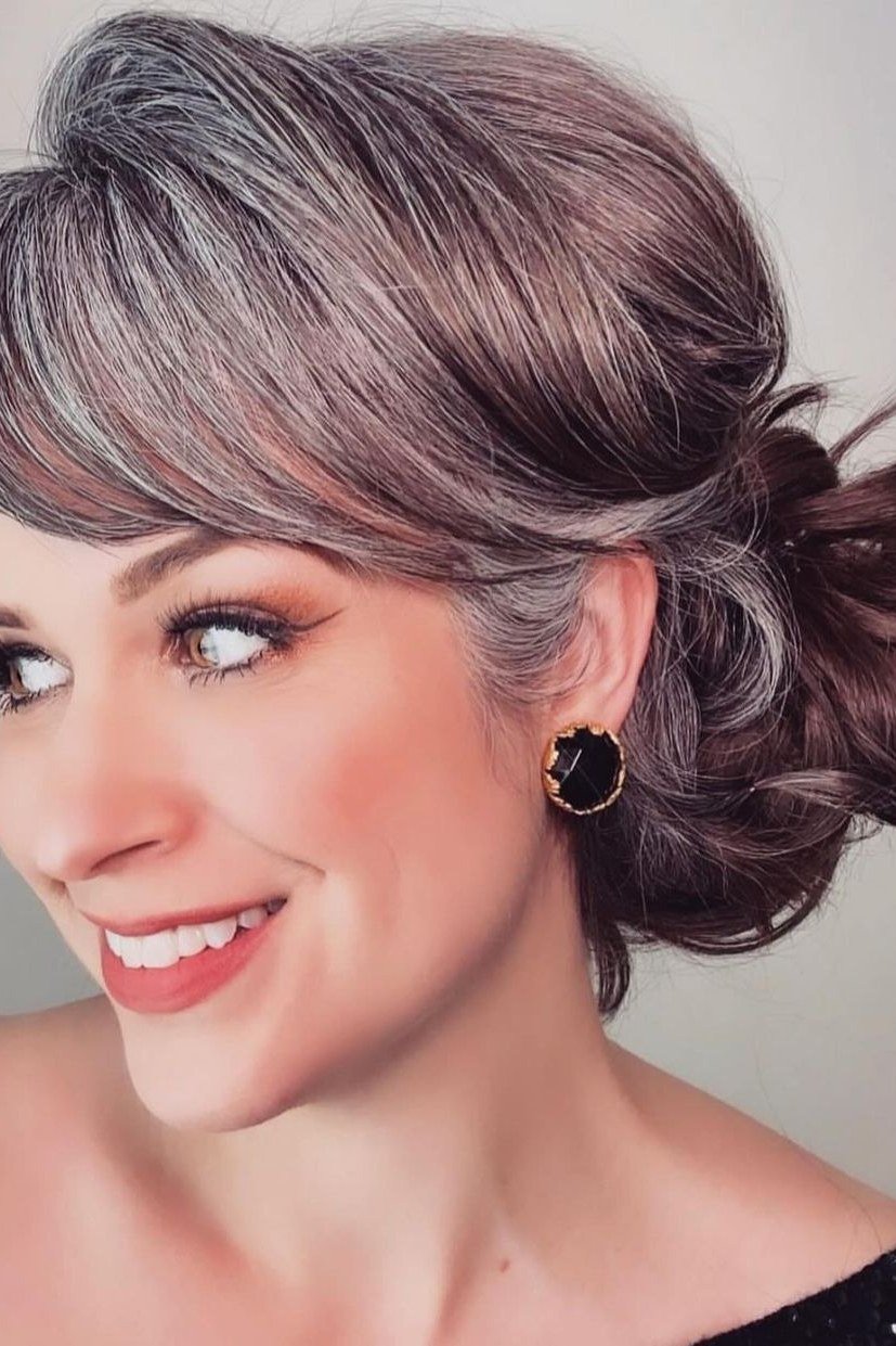 Auburn Low Side Bun - Christmas party hairstyle for women over 60 (auburn low side bun, smiling three-quarter view)
