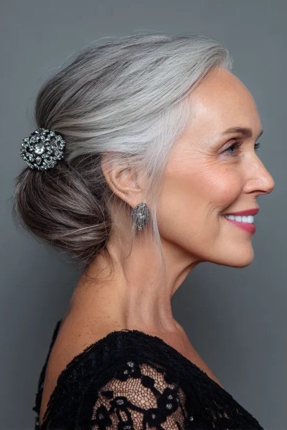 Silver Low Bun With Crystal Brooch Pin - Christmas party hairstyle for women over 60 (silver low bun with crystal brooch pin, side view)