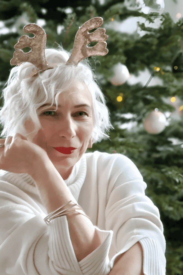 White Curly Pixie With Reindeer Antler Headband - Christmas party hairstyle for women over 60 (white curly pixie with reindeer antler headband, front view)