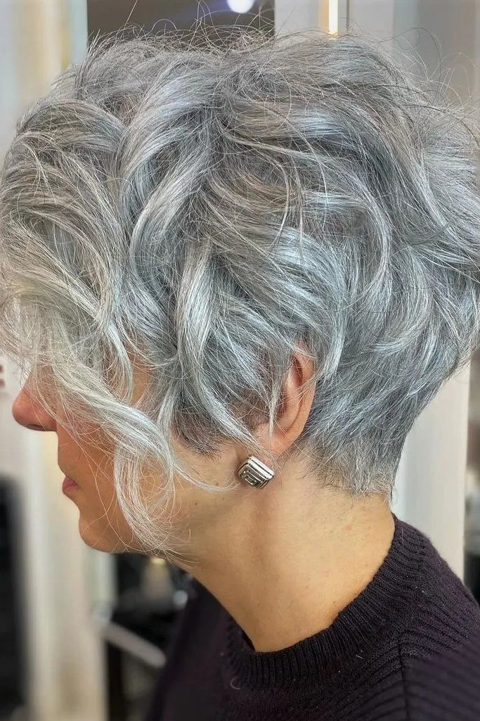 Curly silver pixie cut with movement, side view