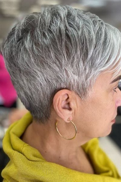Silver pixie haircut in warm golden light, side view