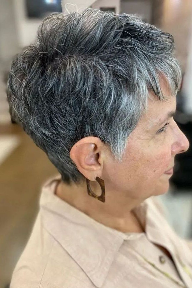 Salon-textured salt and pepper pixie cut, side view