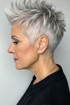 Grey pixie haircut for women over 50: silver spiky pixie, side view, black top