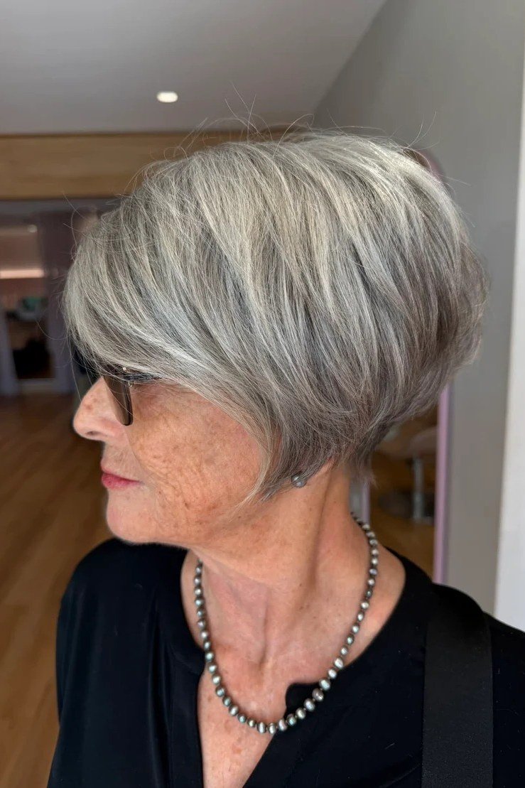 Grey pixie haircut for women over 50: grey pixie, three-quarter view, salon background
