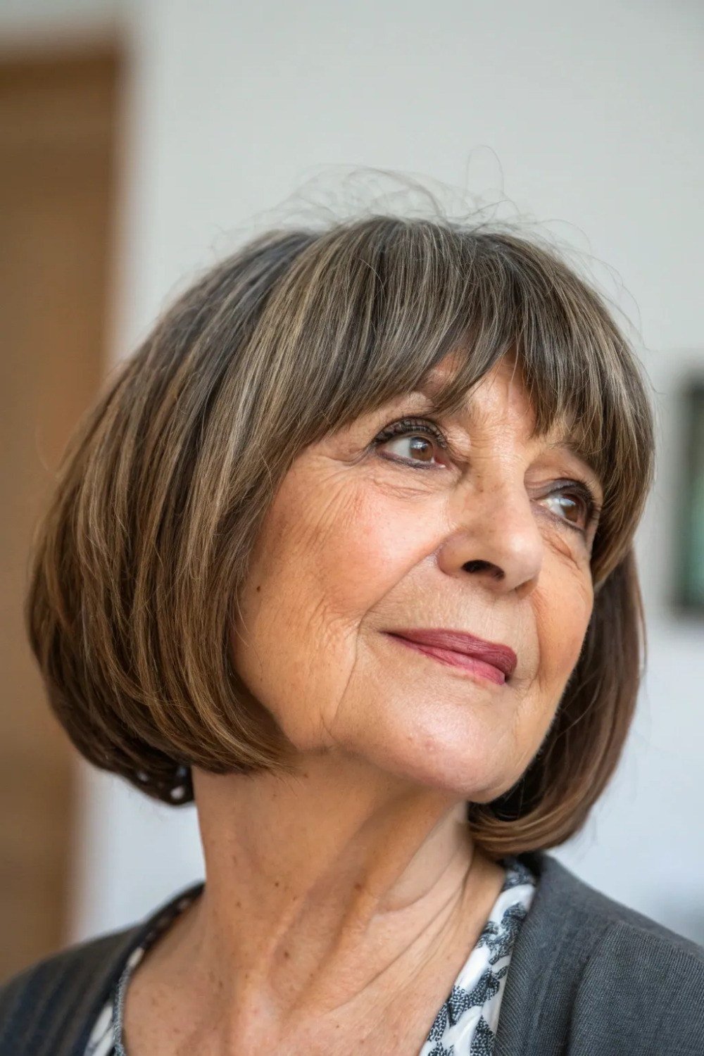 Brown bob haircut with bangs for women over 60, front view