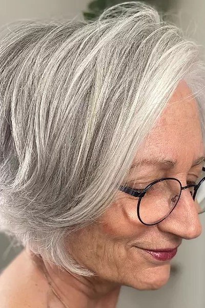 Silver layered bob haircut with glasses, side profile view