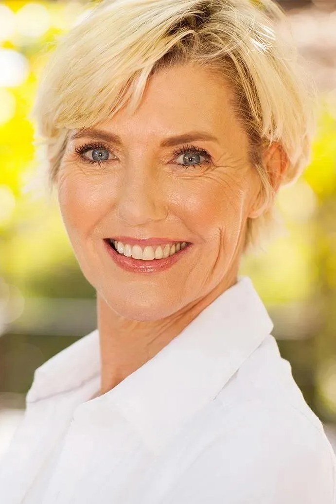 Blonde pixie haircut for women over 60, outdoor front view