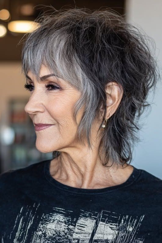 Dark shaggy pixie haircut, side profile view