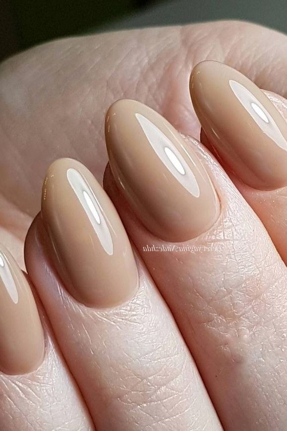 high-gloss beige almond nails - honey glazed nude nails for women over 50