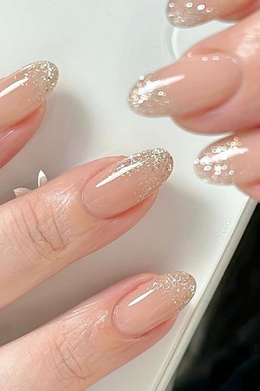 pink almond nails with glitter french tips - honey glazed nude nails for women over 50