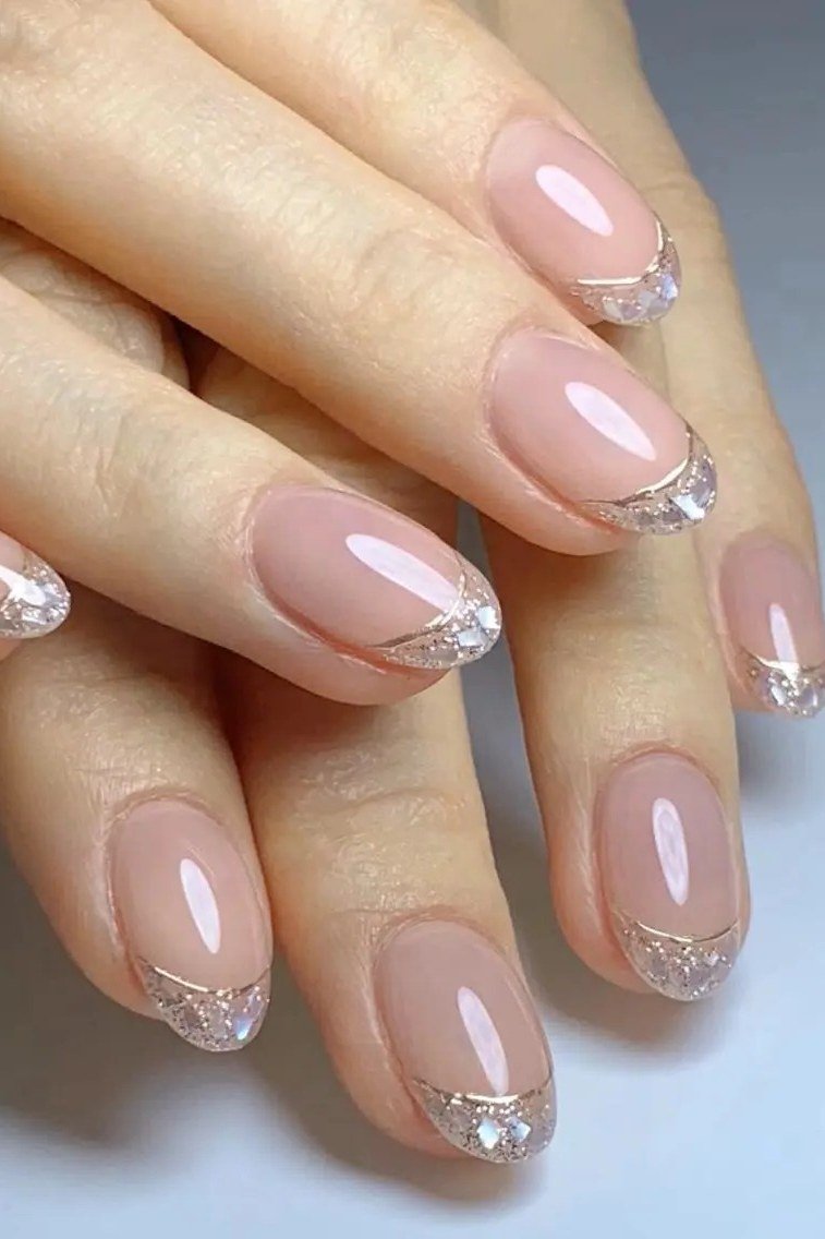 nude almond nails with silver glitter french tips - honey glazed nude nails for women over 50