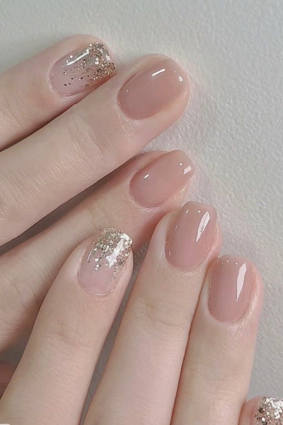 nude squoval nails with a gold glitter accent - honey glazed nude nails for women over 50