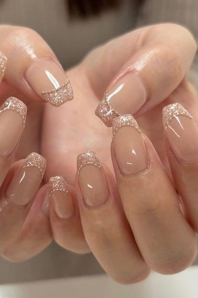 nude squoval nails with glitter french tips - honey glazed nude nails for women over 50