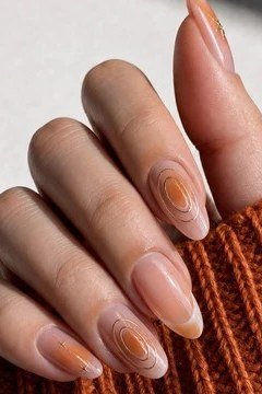 honey brown almond nails with amber circle art - honey glazed nude nails for women over 50
