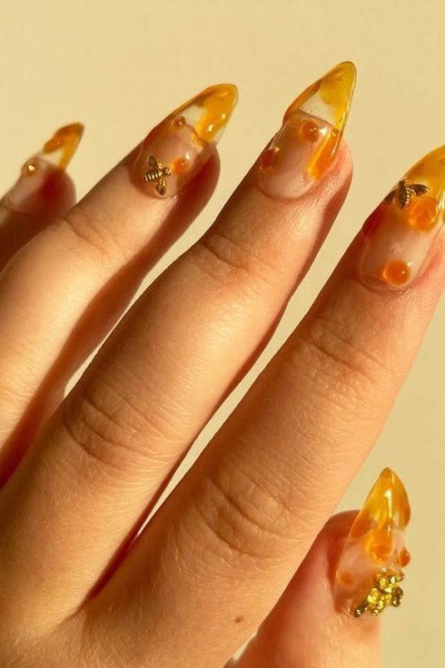 amber jelly nails with bee accents - honey glazed nude nails for women over 50
